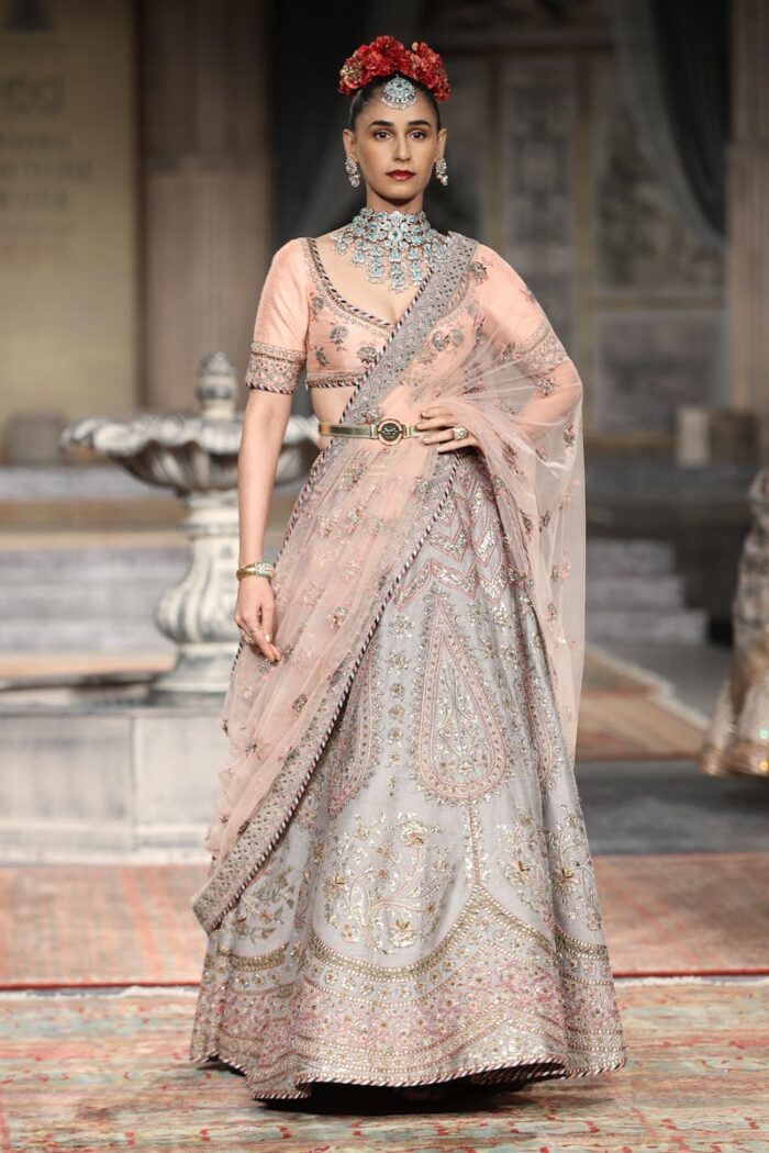 Stunning Indian model in embroidered saree on fashion runway, New Delhi.